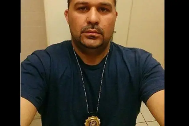 Jason Forgetta posing with a badge on Facebook
